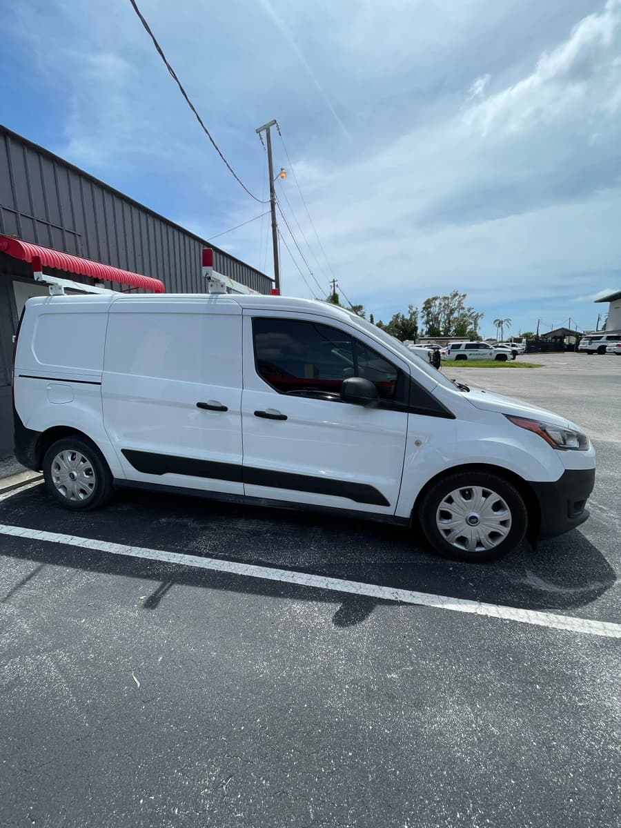 Plain white Ford Transit Connect before custom wrap
