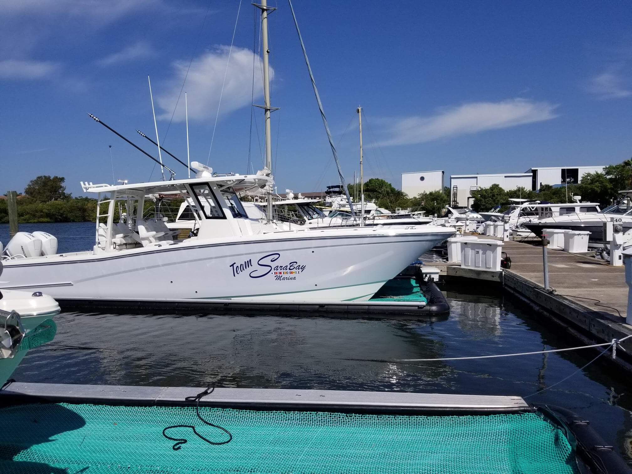 Custom boat graphics and lettering on a vessel serviced by Auto Trim Design of Suncoast