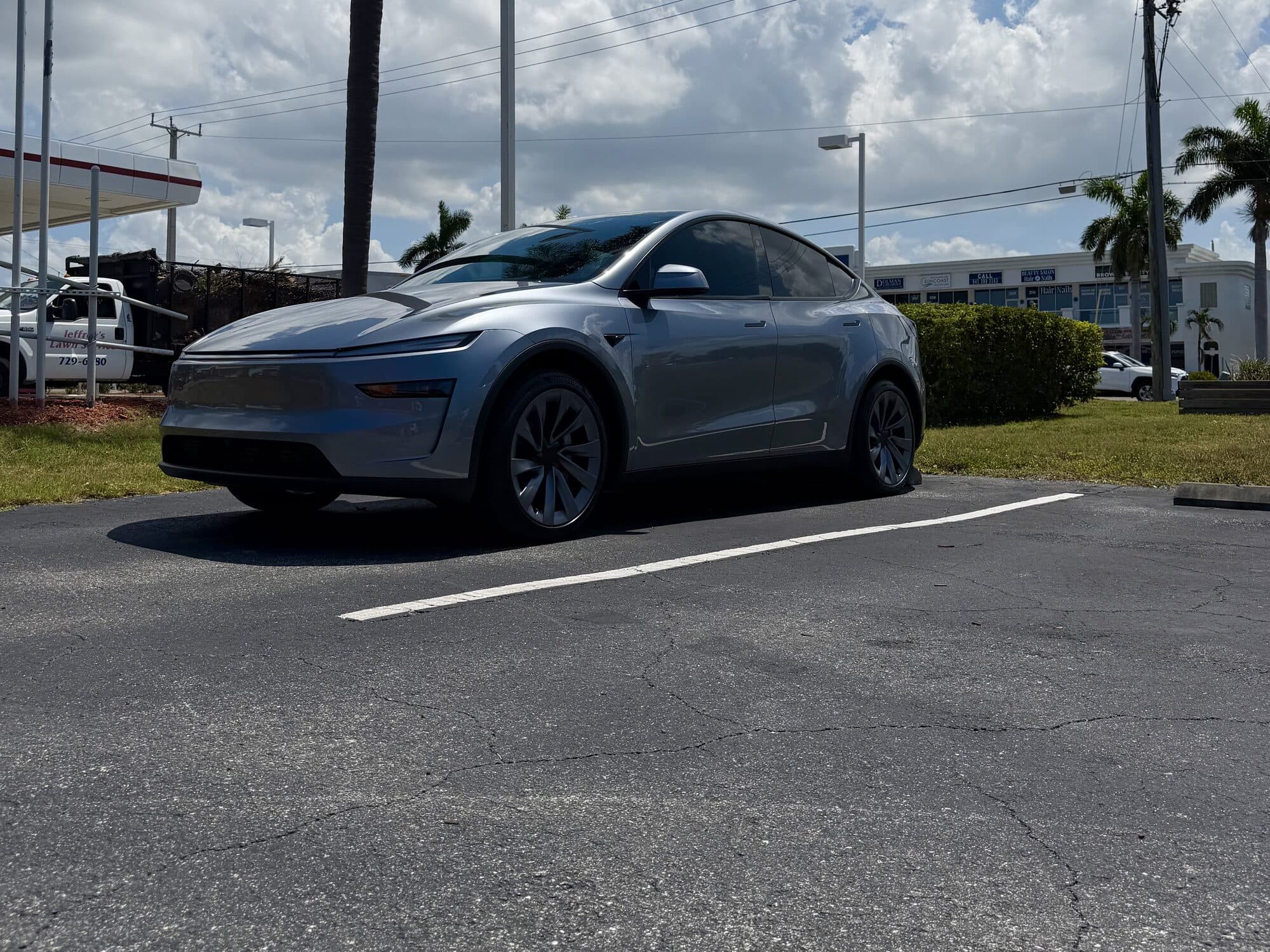 Silver Tesla Model Y with window tint by ATD Suncoast
