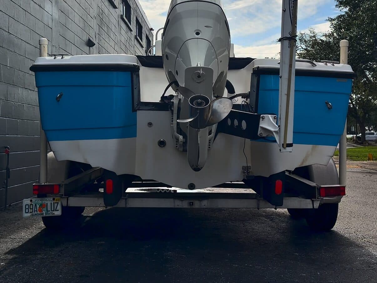 Center console transom and outboard with custom blue wrap by ATD Suncoast