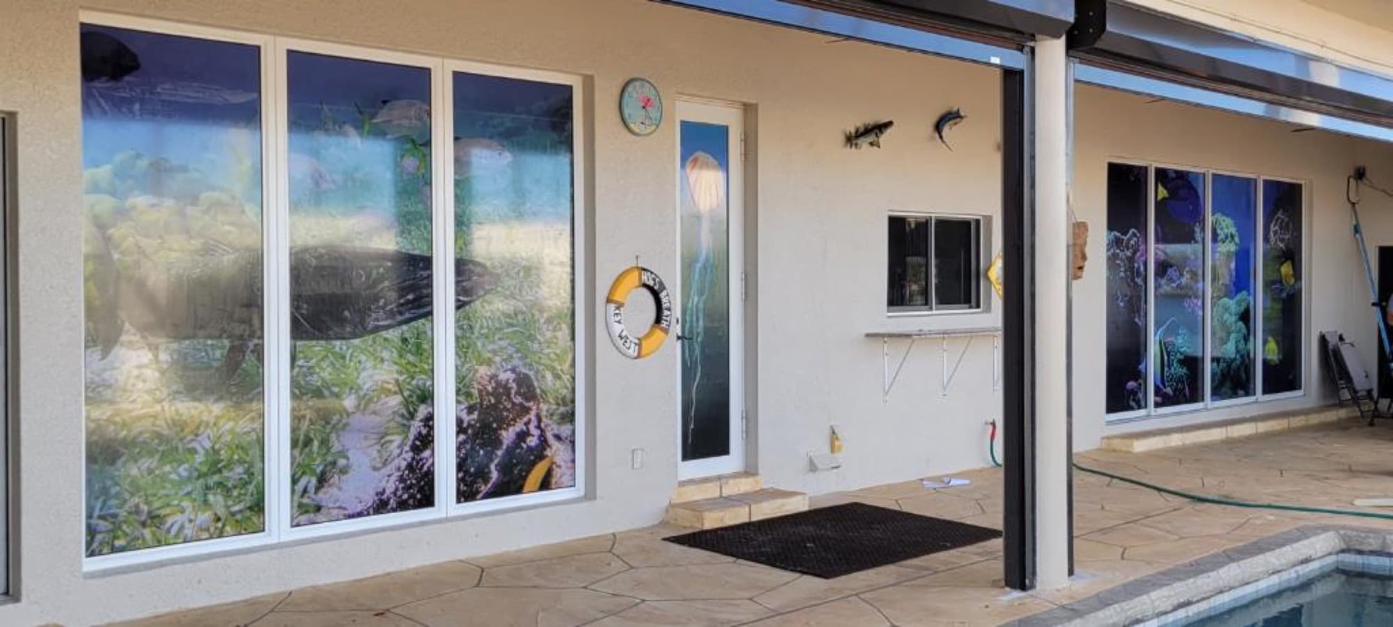 Custom underwater reef window vision graphics on poolside windows by ATD
